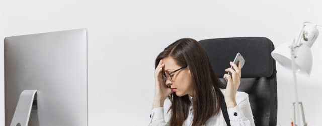 Businesswoman is fed up with the other members of the phone conference