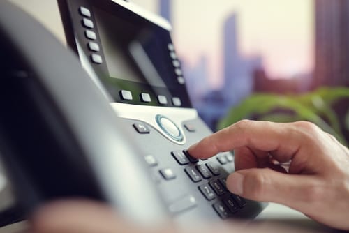 Someone-dialing-an-office-phone